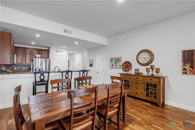 dining area featuring light wood-type flooring