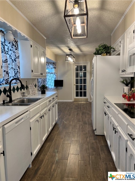 kitchen featuring white cabinets, white appliances, and decorative light fixtures