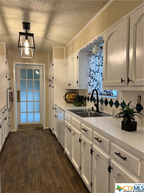 kitchen featuring tasteful backsplash, sink, white cabinets, and wall oven