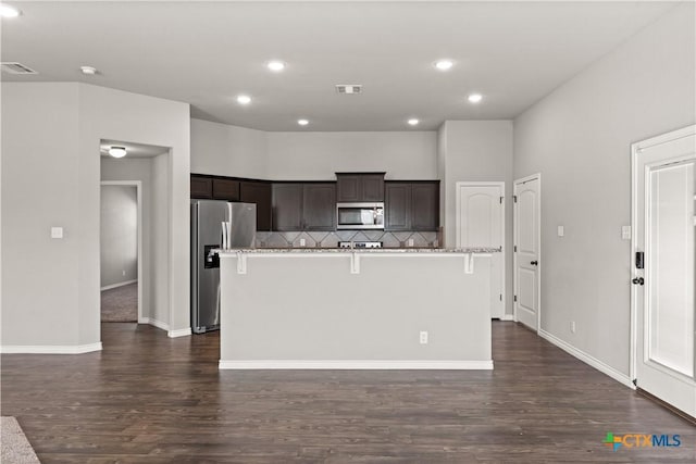 kitchen with dark wood-style flooring, visible vents, stainless steel appliances, and dark brown cabinets