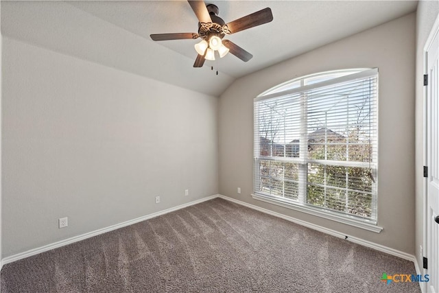 unfurnished room with lofted ceiling, carpet, a ceiling fan, and baseboards