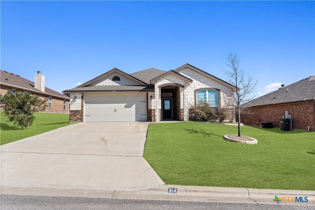 french country style house featuring an attached garage, driveway, stone siding, and a front yard