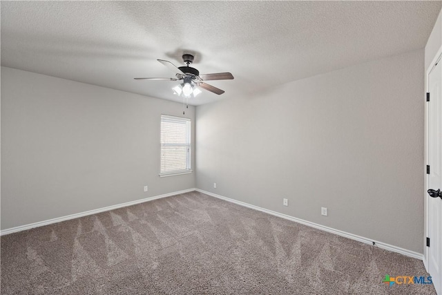 carpeted empty room with a ceiling fan, a textured ceiling, and baseboards