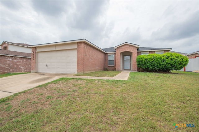 single story home with a garage and a front lawn