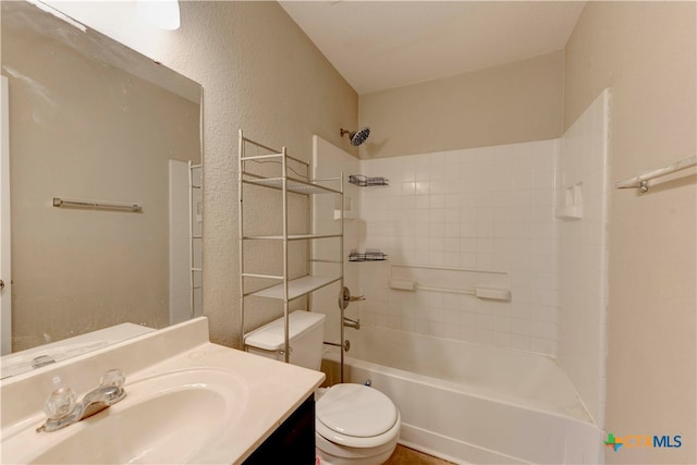 full bathroom with vanity, tiled shower / bath combo, and toilet