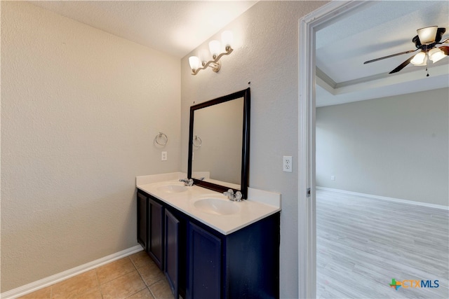 bathroom featuring vanity, ceiling fan, and wood-type flooring