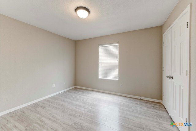 unfurnished bedroom featuring light hardwood / wood-style floors