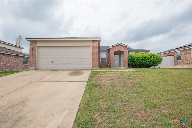 single story home featuring a garage and a front lawn