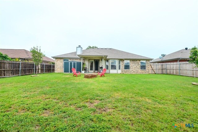 4413 Pete Dr, Killeen, TX 76549 - rear view of property with an outdoor fire pit and a chimney
