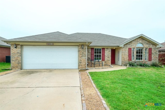 4413 Pete Dr, Killeen, TX 76549 - ranch-style home featuring concrete driveway, an attached garage, a front yard, brick siding, and roof with shingles