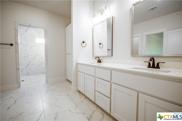 bathroom with vanity and tiled shower