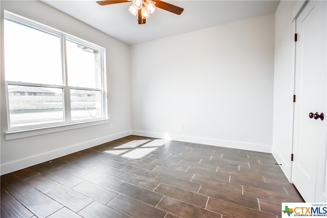 spare room with a wealth of natural light and ceiling fan