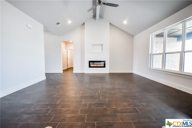 unfurnished living room featuring lofted ceiling with beams, ceiling fan, a large fireplace, and dark hardwood / wood-style floors