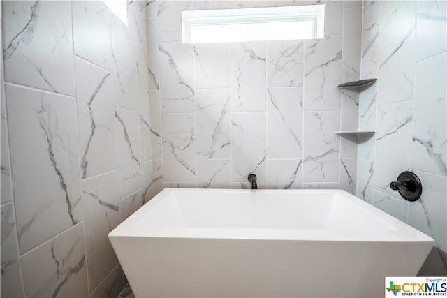 bathroom with a tub to relax in