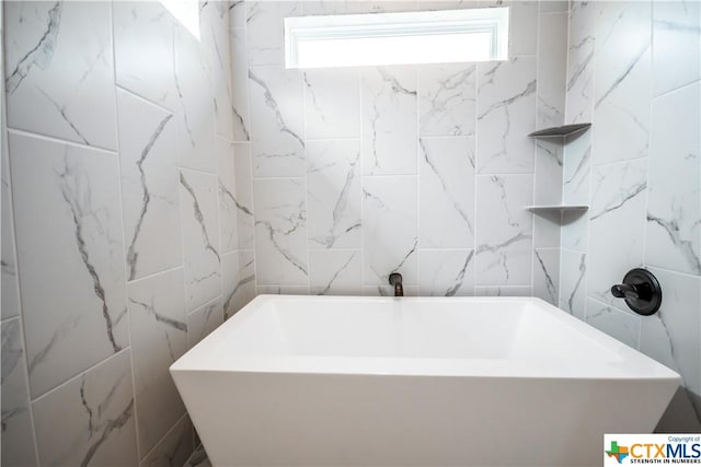 8500 Kasen Ave, Killeen, TX 76542 - full bath with tile walls, a freestanding tub, and plenty of natural light