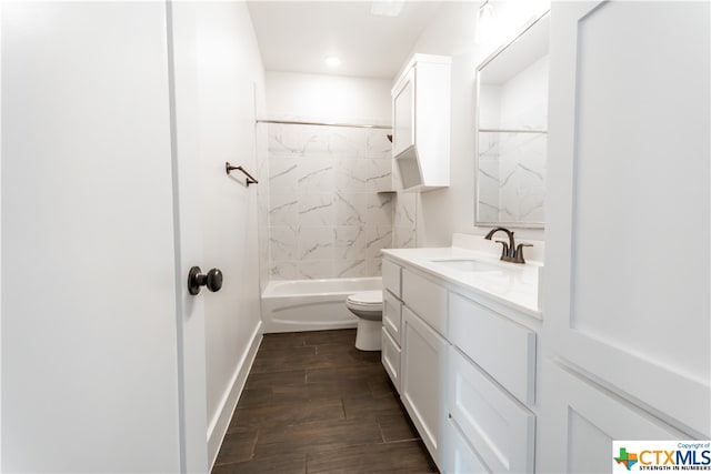 full bathroom with hardwood / wood-style floors, vanity, toilet, and tiled shower / bath combo