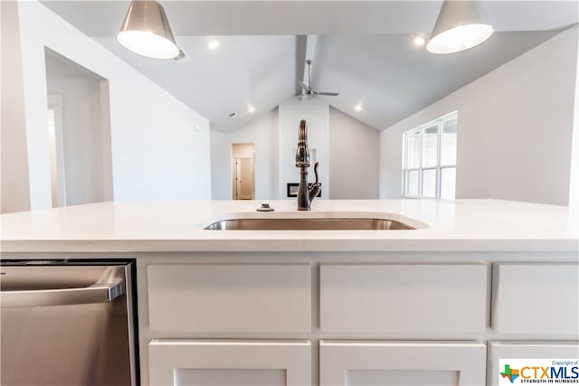 kitchen featuring stainless steel dishwasher, ceiling fan, sink, and vaulted ceiling