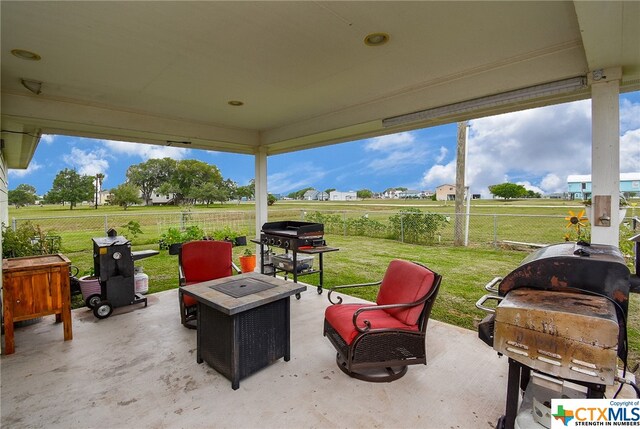 view of patio / terrace with a grill and a fire pit