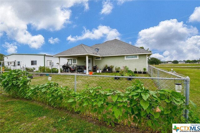 rear view of house featuring a yard and a patio area