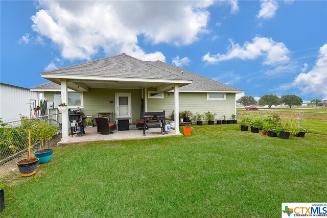 back of house with a yard and a patio area