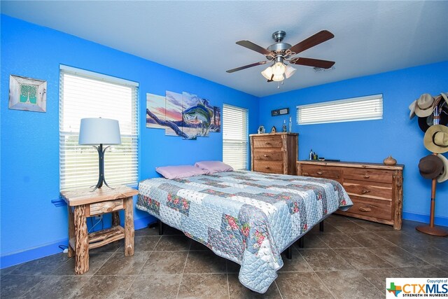 bedroom with multiple windows and ceiling fan