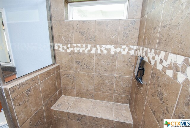 bathroom with a tile shower