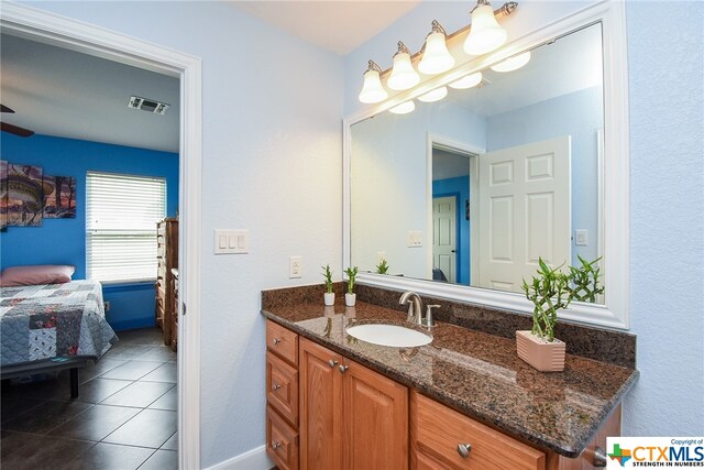 bathroom featuring tile patterned flooring and vanity