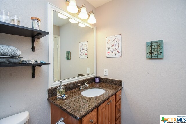 bathroom featuring vanity and toilet