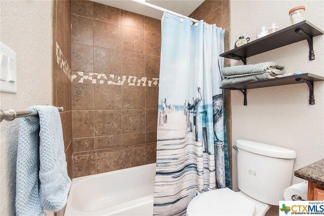 full bathroom featuring vanity, shower / bath combo with shower curtain, and toilet