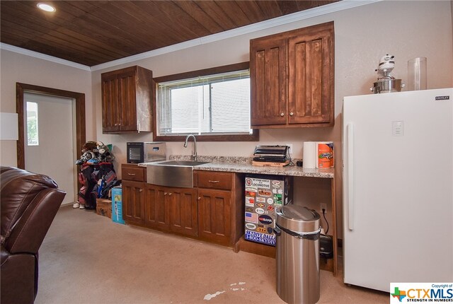 kitchen with light colored carpet, wood ceiling, a healthy amount of sunlight, and white refrigerator