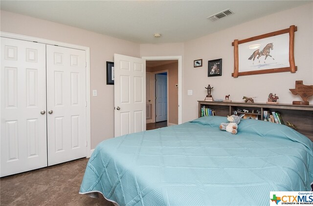 bedroom with tile patterned flooring and a closet