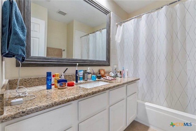 bathroom featuring shower / bath combination with curtain and vanity