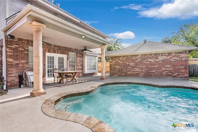 view of pool with a patio and ceiling fan