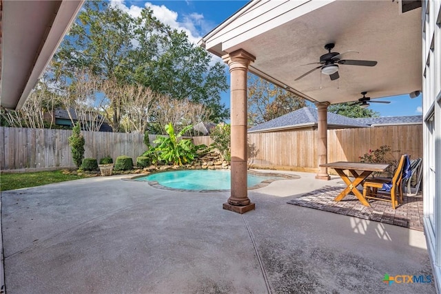 view of patio with a fenced in pool and ceiling fan