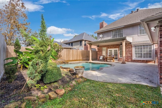 view of swimming pool featuring a patio area and french doors