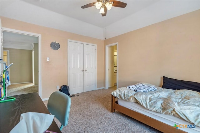 bedroom with carpet flooring, ceiling fan, a closet, and vaulted ceiling