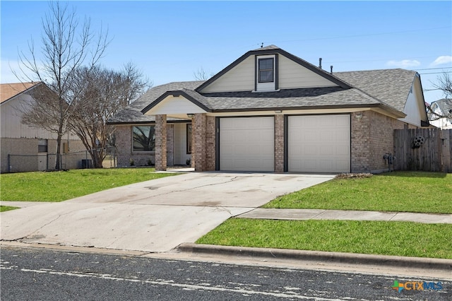 view of front facade with a garage, brick siding, a shingled roof, fence, and a front lawn