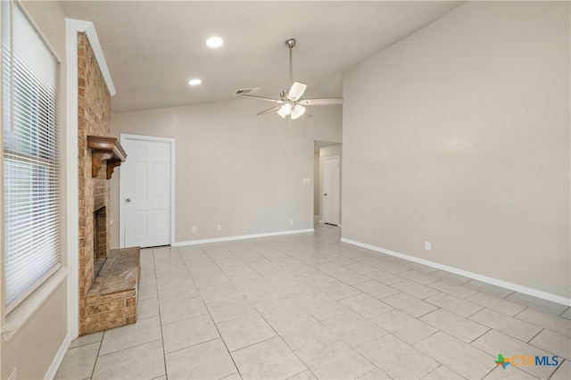 unfurnished room featuring a fireplace, visible vents, a ceiling fan, vaulted ceiling, and baseboards