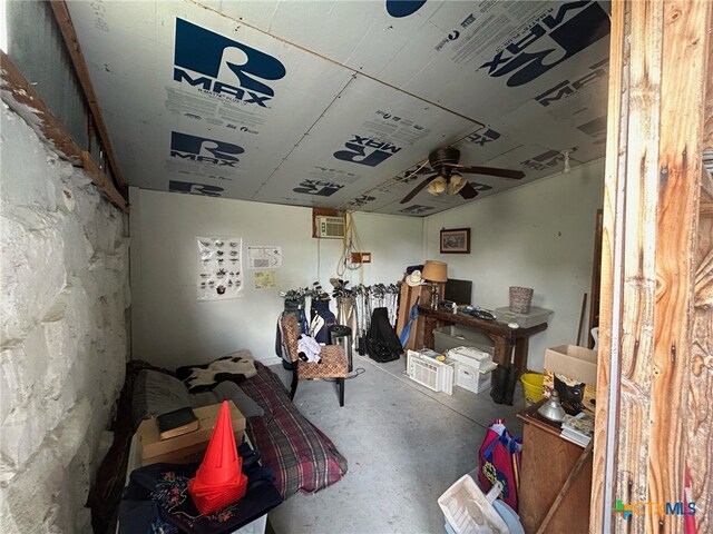 misc room with concrete flooring and ceiling fan