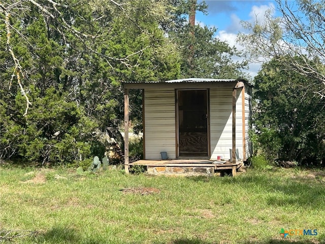 view of outbuilding with a lawn