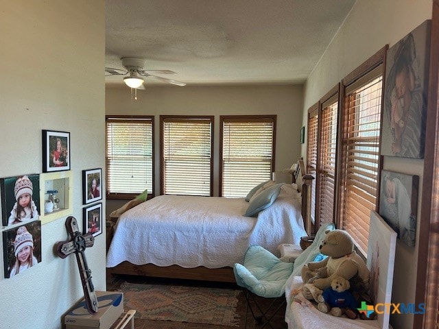 bedroom featuring ceiling fan and multiple windows