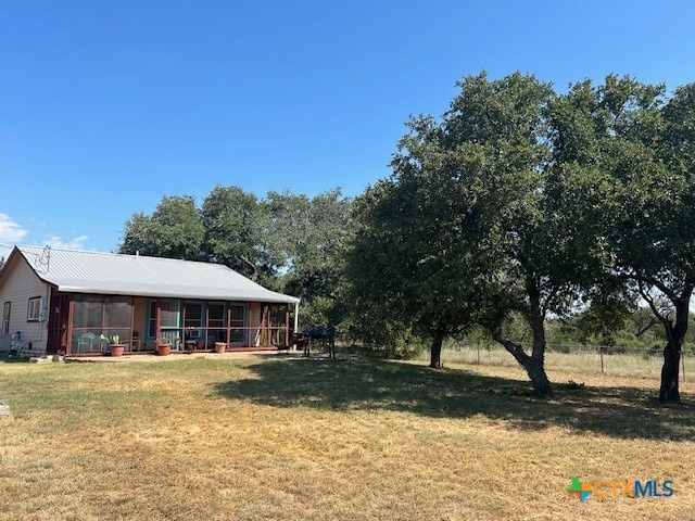 view of yard featuring a sunroom