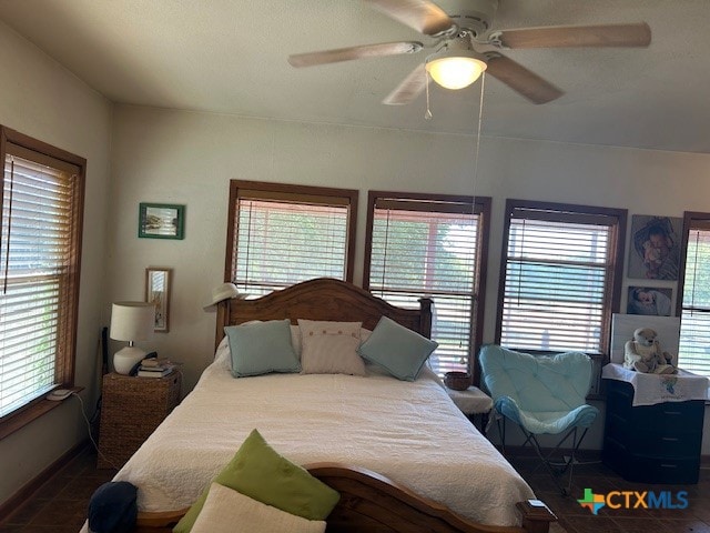 bedroom featuring multiple windows and ceiling fan