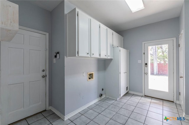 washroom featuring cabinet space, light tile patterned floors, baseboards, hookup for an electric dryer, and hookup for a washing machine