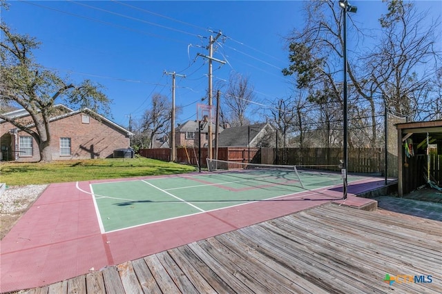 exterior space featuring a tennis court, community basketball court, a yard, and fence