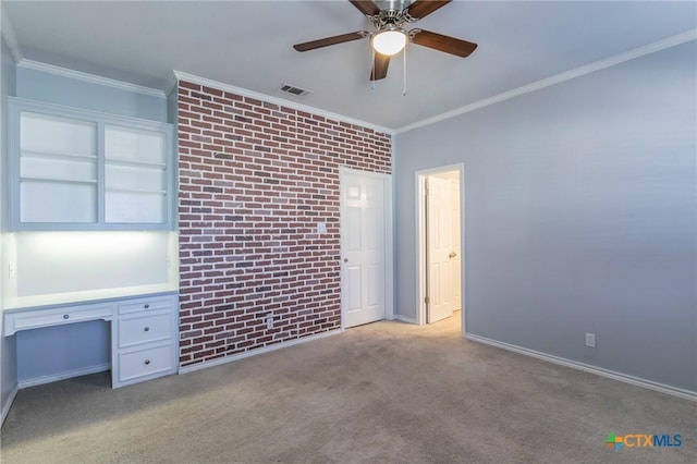 unfurnished bedroom with carpet flooring, visible vents, brick wall, and ornamental molding