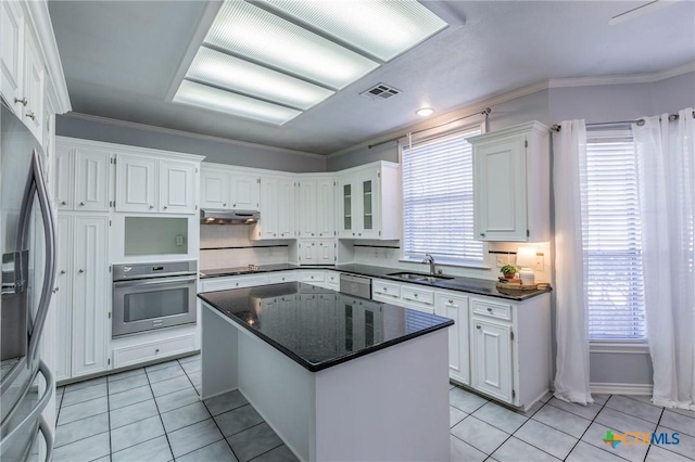 kitchen with visible vents, light tile patterned flooring, under cabinet range hood, appliances with stainless steel finishes, and white cabinetry