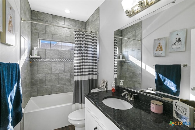 bathroom with toilet, vanity, and shower / tub combo