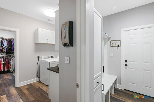 washroom featuring dark wood-style floors, cabinet space, hookup for an electric dryer, and baseboards