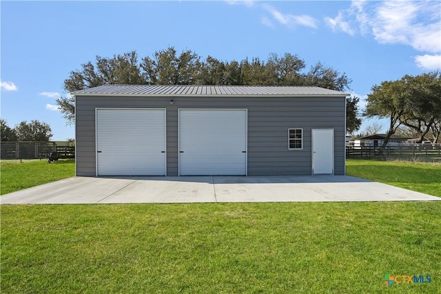 detached garage featuring fence